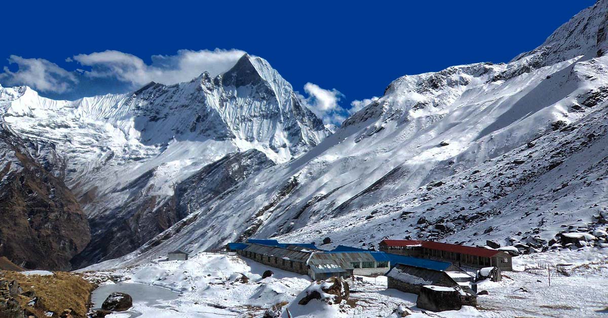 A snowy mountain with buildings in Annapurna base Camp. One of the must popular trekking trail of Western Nepal 